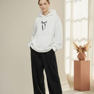 Women's casual hoodie featuring a minimalist black coquette bow graphic on the chest