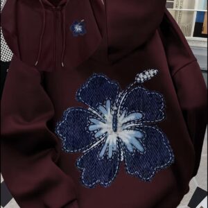 Maroon zip-up hoodie with a large textured blue floral graphic on the back and a matching small flower on the chest.