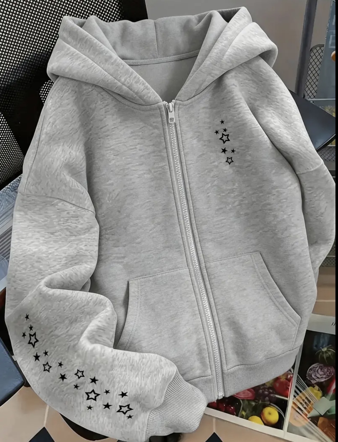 Zip-up hoodie featuring a white star and constellation-style graphic on the right chest and extending across the right sleeve.