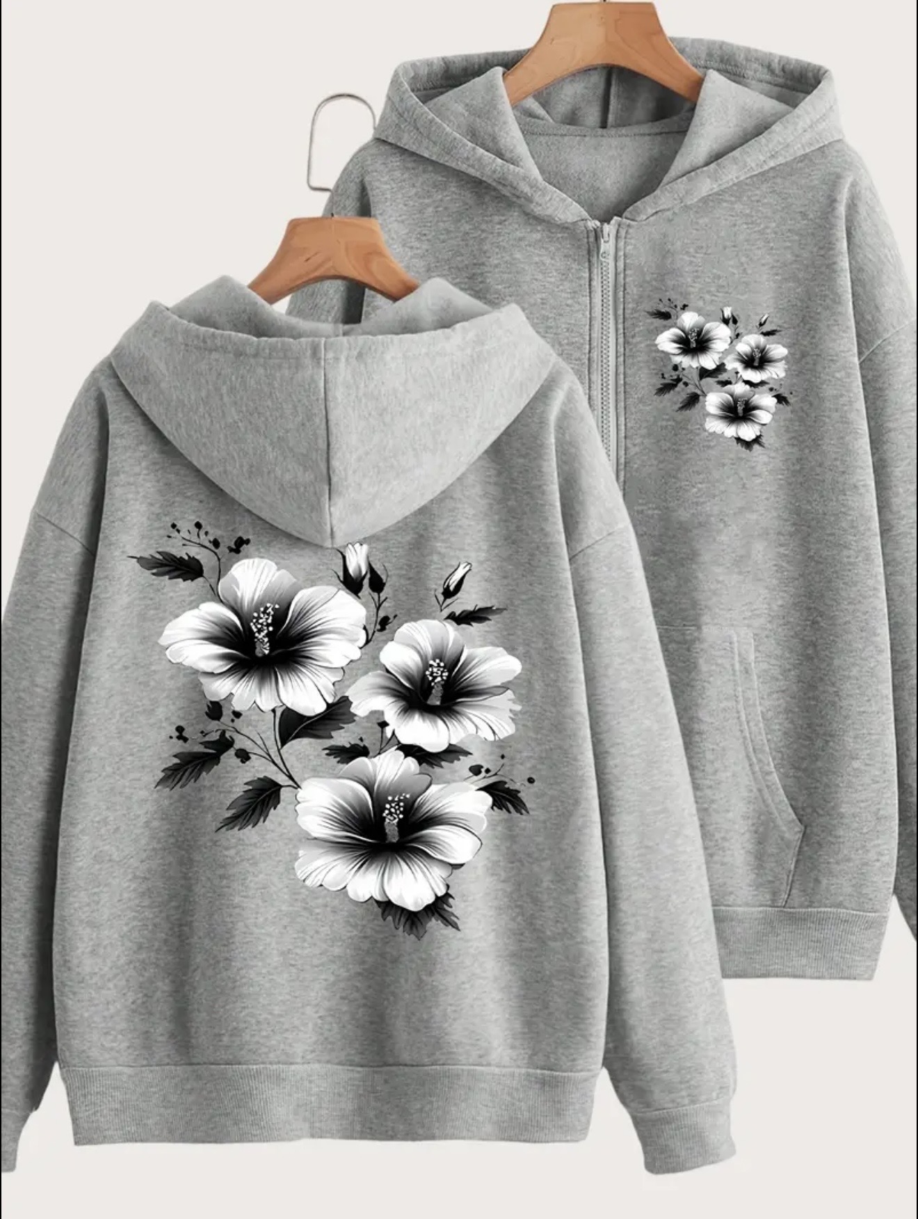 Fleece zipper hoodie with black-and-white hibiscus floral print on the left chest and a large matching flower design on the back.