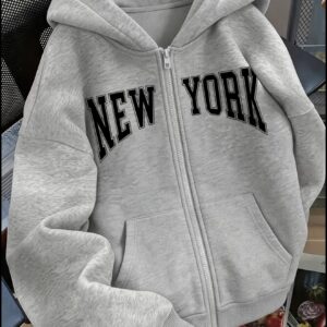 Zip-up hoodie featuring bold black collegiate-style NEW YORK lettering across the chest.