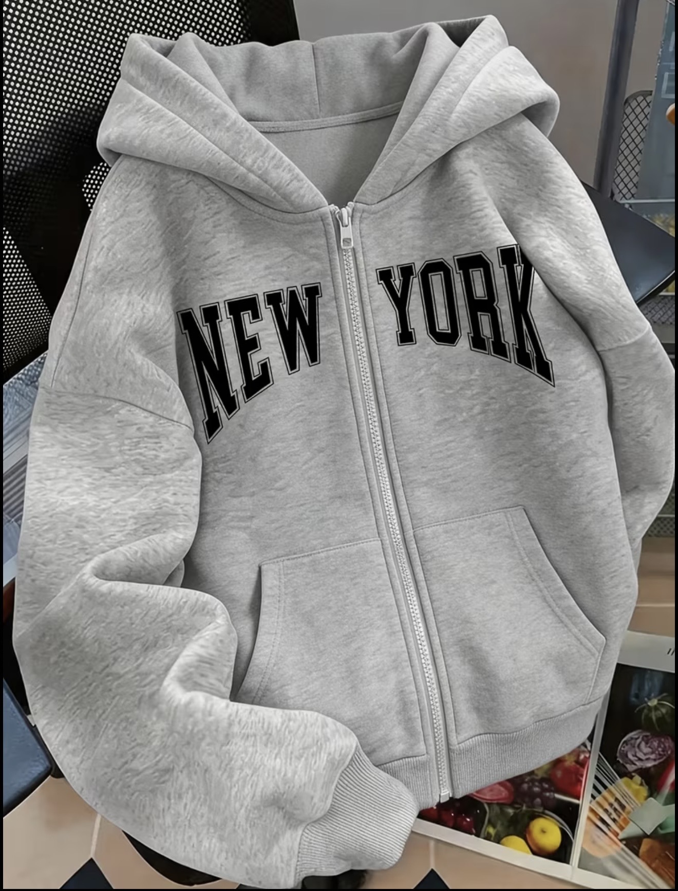 Zip-up hoodie featuring bold black collegiate-style NEW YORK lettering across the chest.