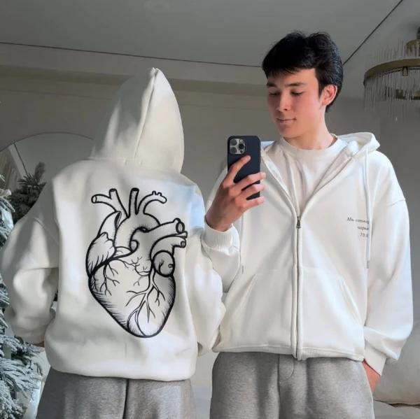 Black zip-up hoodie featuring an anatomical heart graphic print on the back