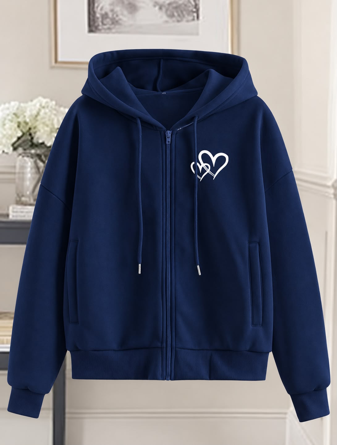 Women's zip-up hoodie with a small black heart-line graphic on the left chest, front pockets, and a drawstring hood.